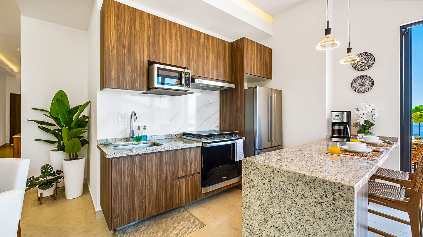Kitchen with five-burner gas stove and stone counters